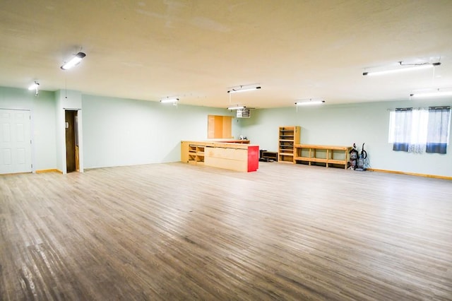 interior space featuring baseboards and wood finished floors