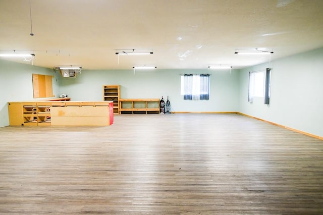 interior space featuring baseboards and wood finished floors
