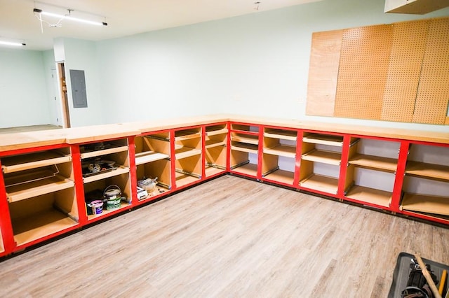 interior space with wood finished floors and electric panel