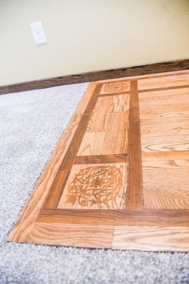 details with baseboards and carpet