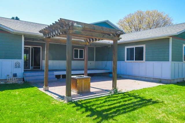 back of house featuring a pergola, a shingled roof, a yard, and a patio area