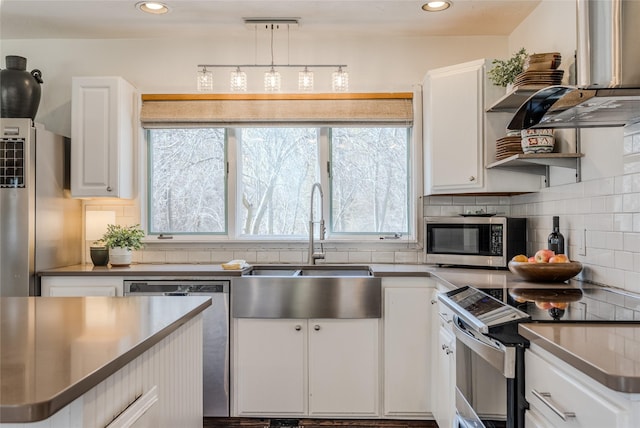 kitchen featuring appliances with stainless steel finishes, white cabinets, open shelves, and backsplash