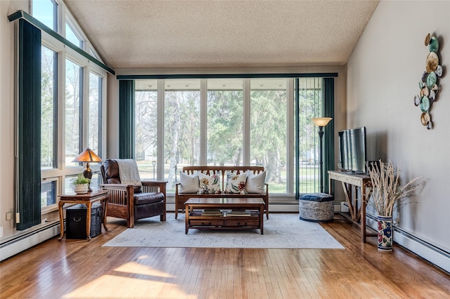 sunroom / solarium with a baseboard heating unit, plenty of natural light, and baseboard heating