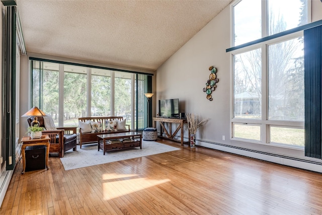 interior space featuring a textured ceiling, expansive windows, high vaulted ceiling, and hardwood / wood-style floors