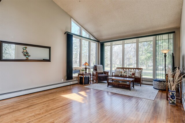 interior space featuring a textured ceiling, high vaulted ceiling, baseboard heating, and hardwood / wood-style floors