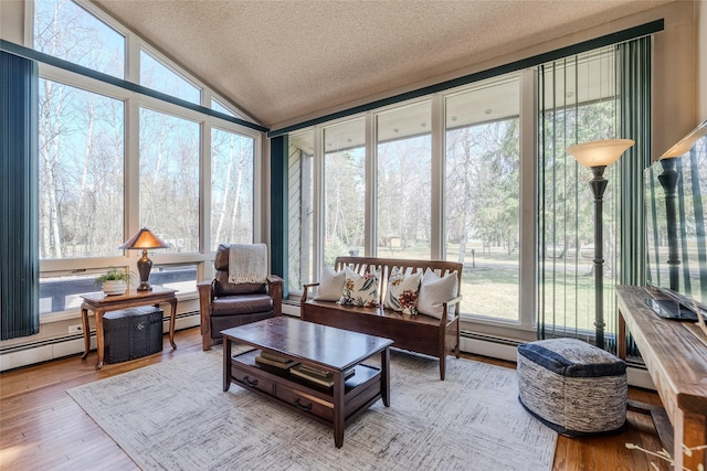 sunroom / solarium with a healthy amount of sunlight, a textured ceiling, and wood finished floors