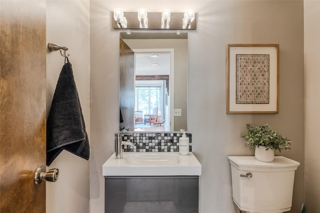 half bath featuring vanity, tasteful backsplash, and toilet