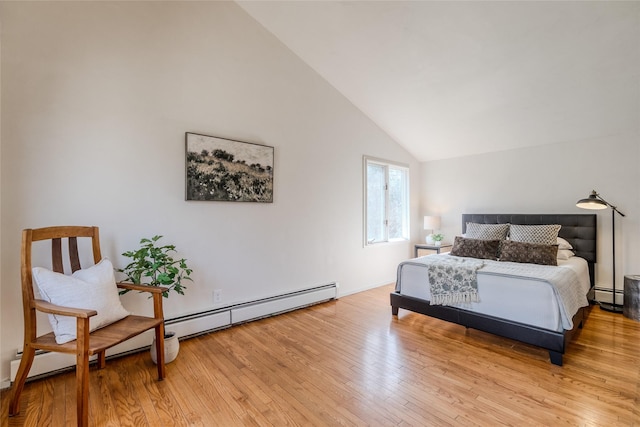 bedroom featuring a baseboard heating unit, lofted ceiling, and light wood-type flooring