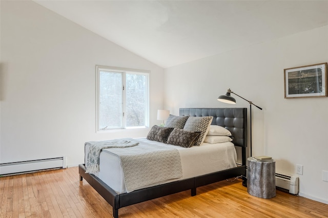 bedroom with light wood-style flooring, lofted ceiling, and a baseboard radiator