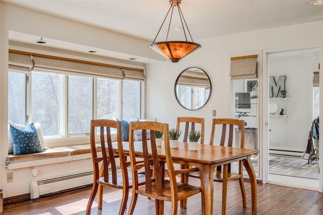 dining area with a baseboard heating unit, recessed lighting, and wood finished floors