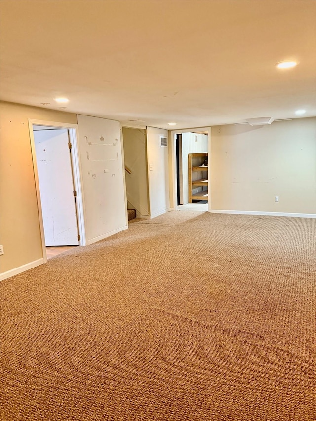 finished below grade area with recessed lighting, baseboards, carpet flooring, and stairs
