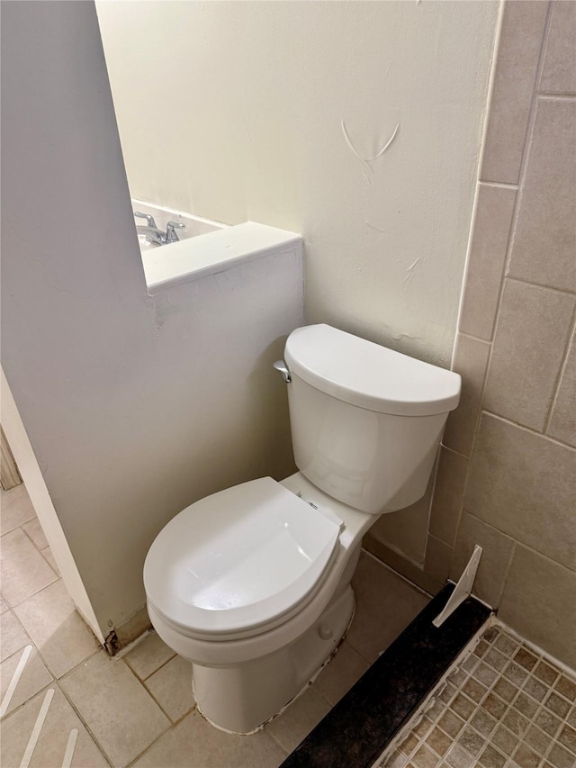 bathroom with tile patterned floors and toilet