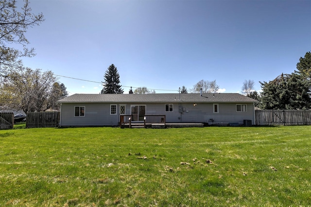 back of house with a yard, fence, a wooden deck, and central AC unit