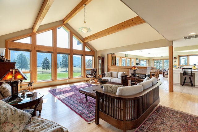 34051 Ridge Rd, Polson, MT 59860 - living room featuring visible vents, lofted ceiling with beams, and light wood-type flooring