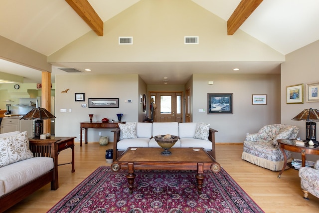 34051 Ridge Rd, Polson, MT 59860 - living room with visible vents, light wood-style flooring, and beamed ceiling