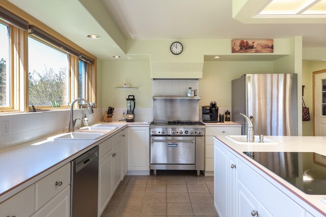 34051 Ridge Rd, Polson, MT 59860 - kitchen with a sink, appliances with stainless steel finishes, light tile patterned floors, and decorative backsplash
