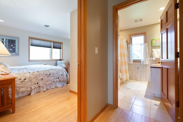 34051 Ridge Rd, Polson, MT 59860 - bedroom featuring visible vents, recessed lighting, light wood-style floors, and ensuite bath