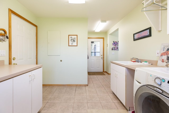 34051 Ridge Rd, Polson, MT 59860 - clothes washing area with washer / clothes dryer, cabinet space, a sink, light tile patterned floors, and baseboards