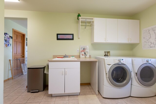 34051 Ridge Rd, Polson, MT 59860 - washroom featuring light tile patterned flooring, washer and dryer, baseboards, a sink, and cabinet space