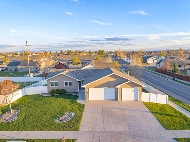 200 37th Ave NE, Great Falls, MT 59404 - view of front facade with a residential view, a front lawn, a garage, a fenced backyard, and driveway