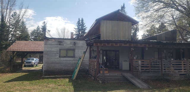 rear view of house featuring a porch