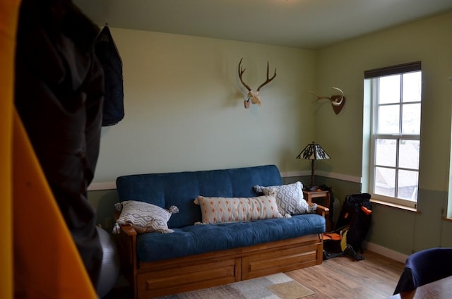 sitting room featuring baseboards and light wood finished floors