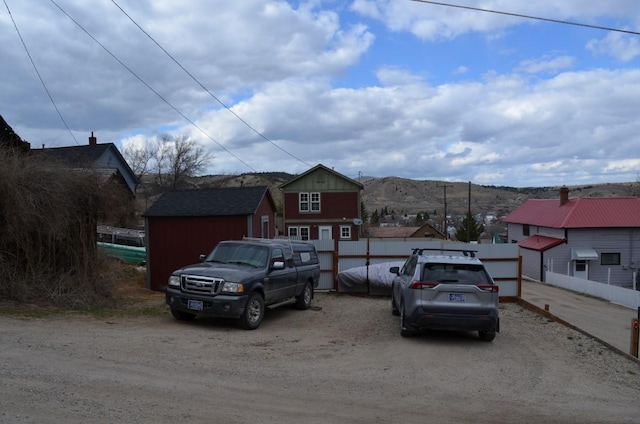 view of front of house featuring fence and a mountain view