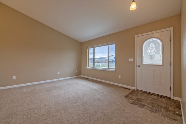 817 Vega Rd, Helena, MT 59602 - entryway featuring baseboards, vaulted ceiling, carpet floors, and visible vents