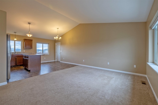 817 Vega Rd, Helena, MT 59602 - kitchen featuring brown cabinetry, visible vents, baseboards, dark colored carpet, and open floor plan