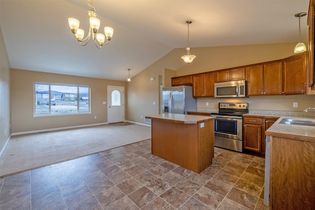 817 Vega Rd, Helena, MT 59602 - kitchen featuring appliances with stainless steel finishes, a sink, dark carpet, a center island, and lofted ceiling