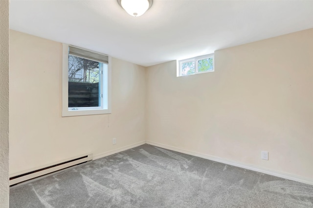 below grade area featuring baseboards, carpet, and a baseboard radiator