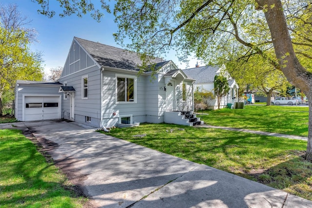view of front of house featuring a garage, a shingled roof, a front yard, and concrete driveway