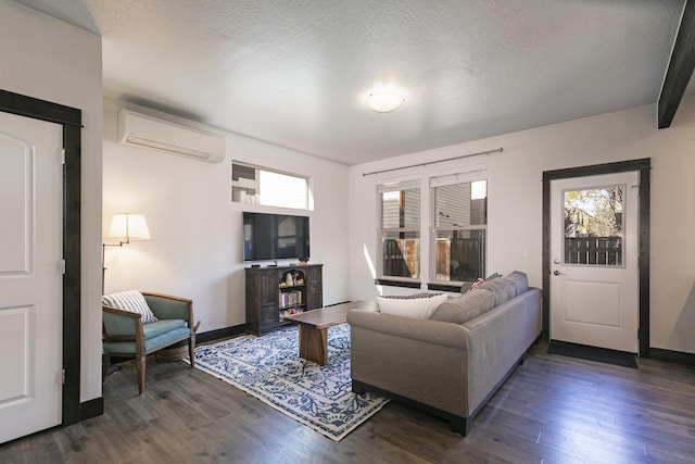 living area featuring baseboards, plenty of natural light, a wall unit AC, and dark wood-style floors