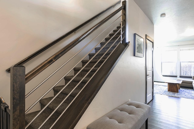 stairway with wood finished floors