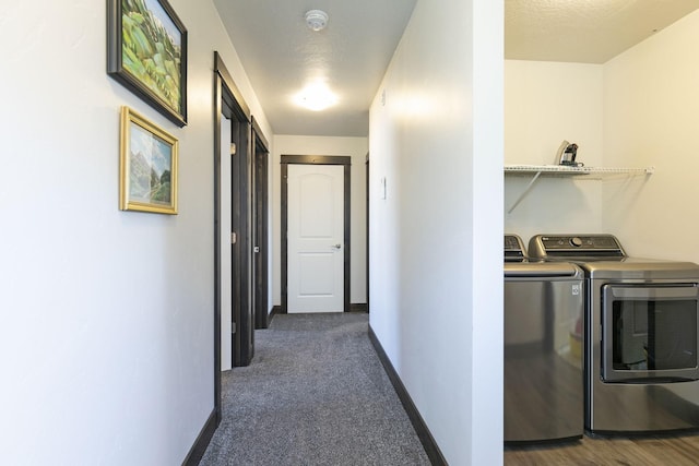 washroom with baseboards, laundry area, dark carpet, and washer and clothes dryer