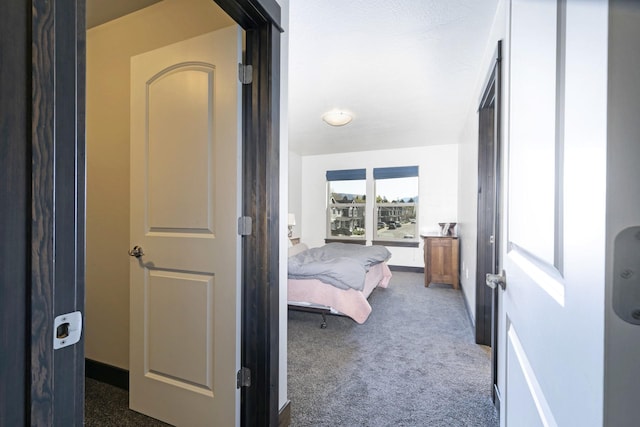 bedroom featuring baseboards and carpet