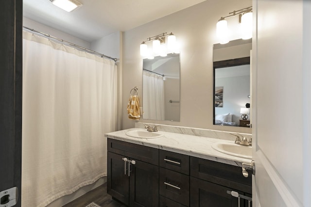 bathroom with double vanity, a sink, and visible vents