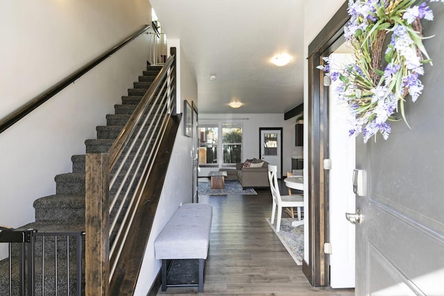 stairway with wood finished floors