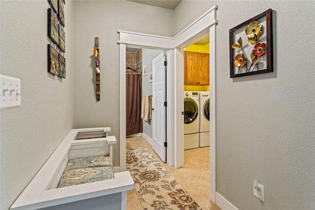 corridor featuring washer and clothes dryer and light carpet