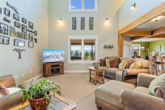 living area with baseboards, carpet flooring, a towering ceiling, and beamed ceiling