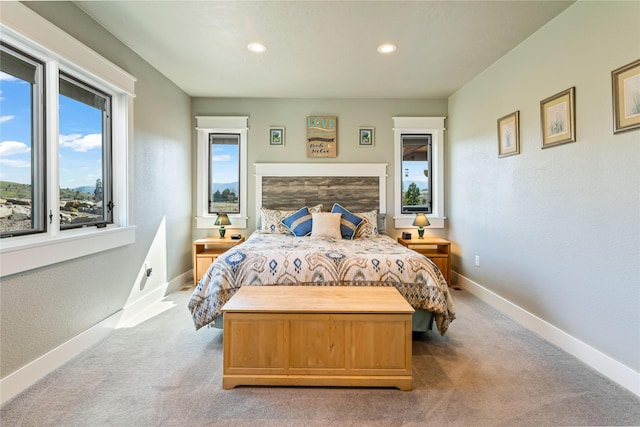 carpeted bedroom featuring baseboards, a textured wall, and recessed lighting