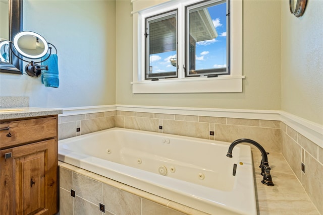 bathroom featuring a whirlpool tub and vanity