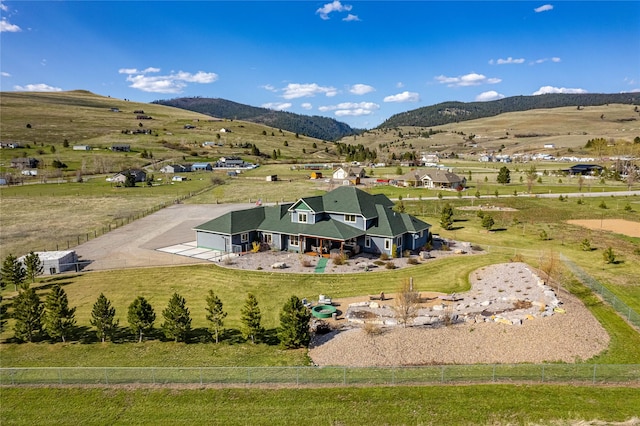 drone / aerial view featuring a mountain view and a rural view