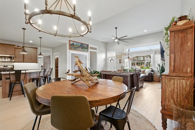 dining space featuring ceiling fan with notable chandelier, recessed lighting, and light wood-style flooring