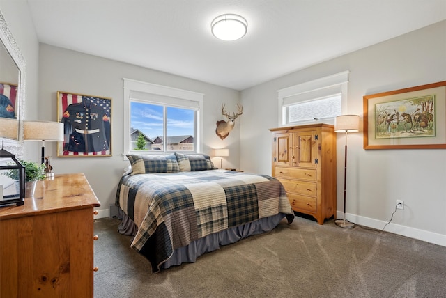 bedroom with carpet floors and baseboards