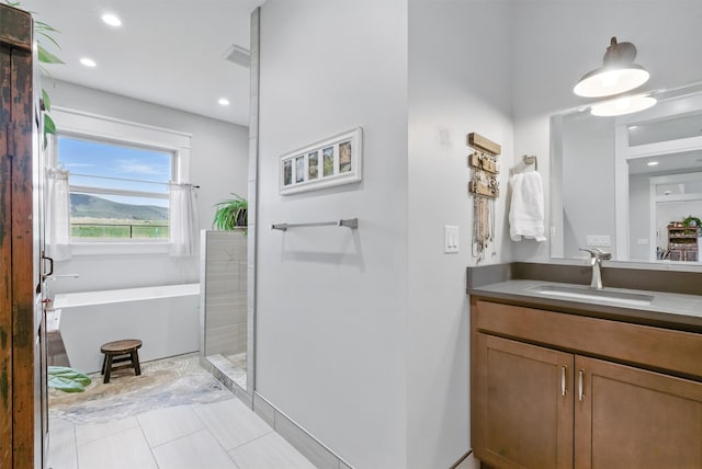 full bath with vanity, tile patterned floors, a bathtub, recessed lighting, and visible vents