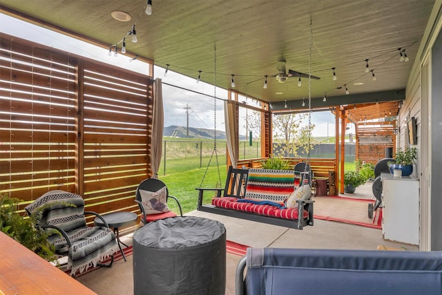 view of patio / terrace featuring fence, a mountain view, and outdoor lounge area