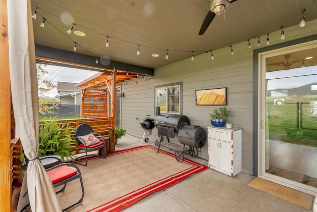 view of patio featuring fence and a ceiling fan