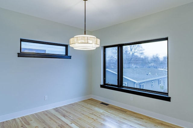 2214 S 12th St W, Missoula, MT 59801 - empty room with plenty of natural light and wood finished floors