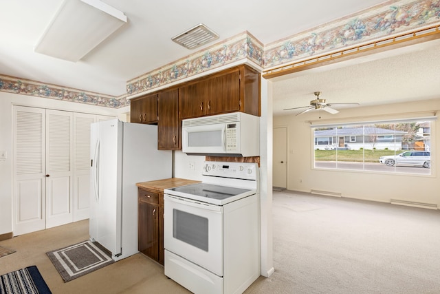 416 Riverview Dr E, Great Falls, MT 59404 - kitchen featuring a ceiling fan, baseboard heating, light countertops, light carpet, and white appliances